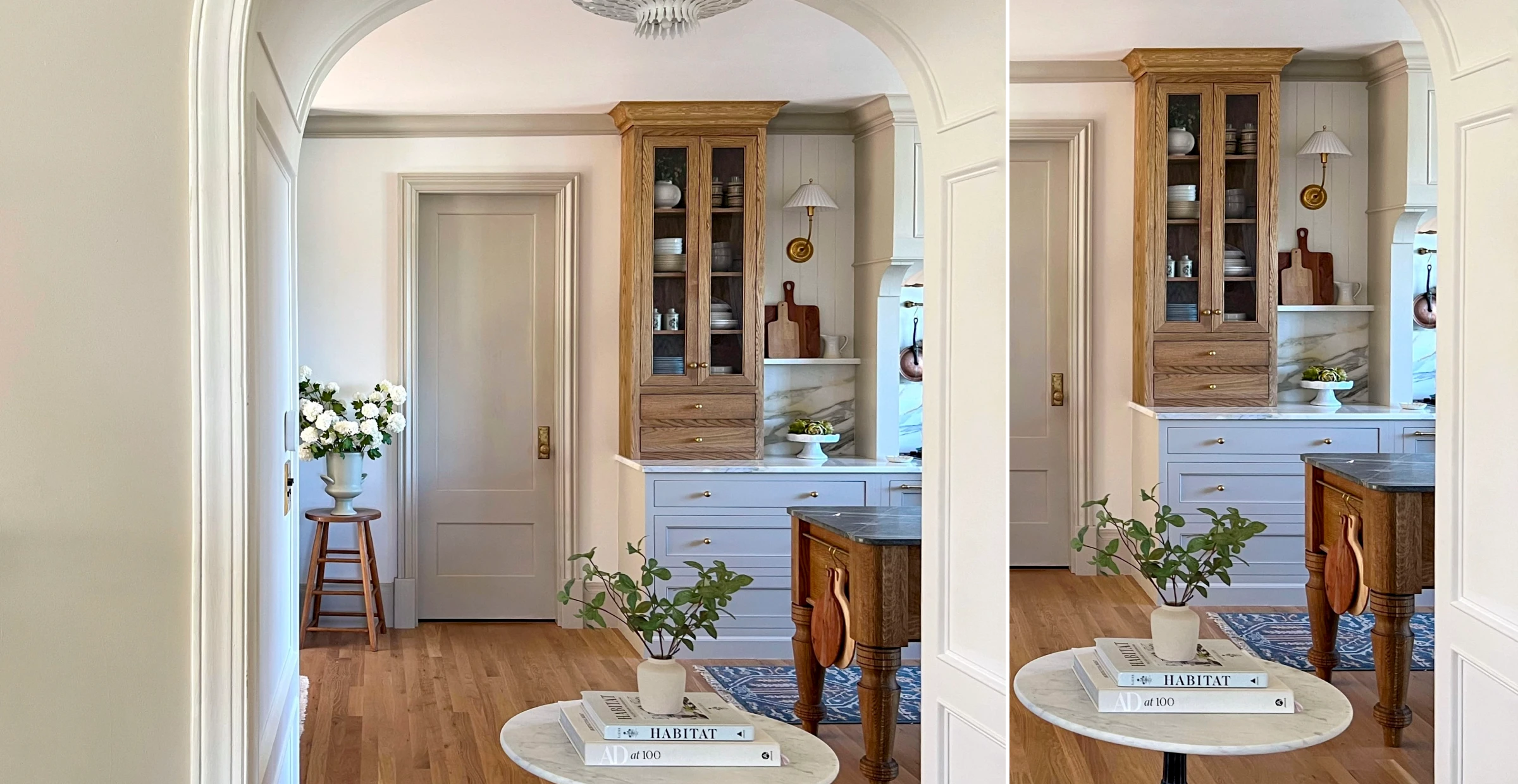 Interior view with arched doorway, round table, potted plant, and cabinet with glass doors